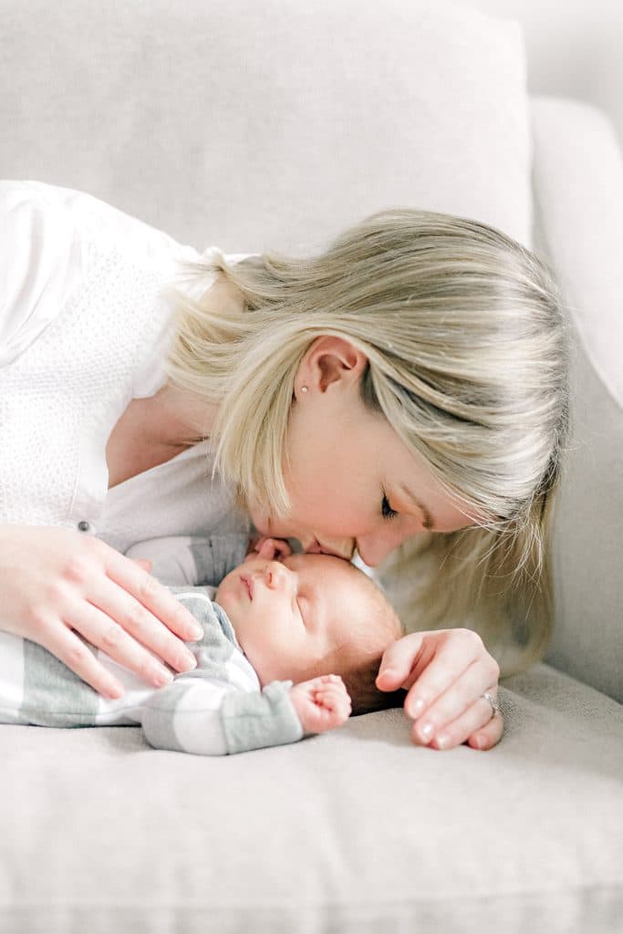 mother kissing her newborn son