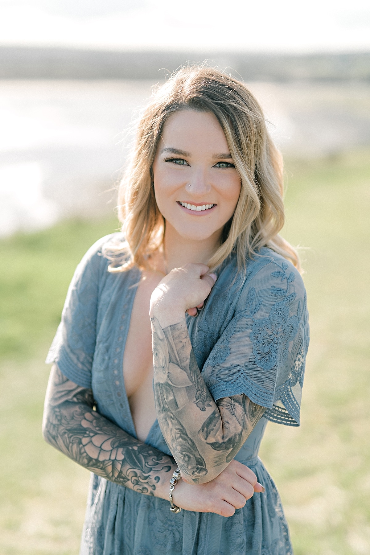portrait of a girl in blue lace dress with tattoos and sunshine