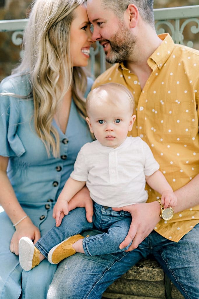 little baby boy sitting on parents lap staring